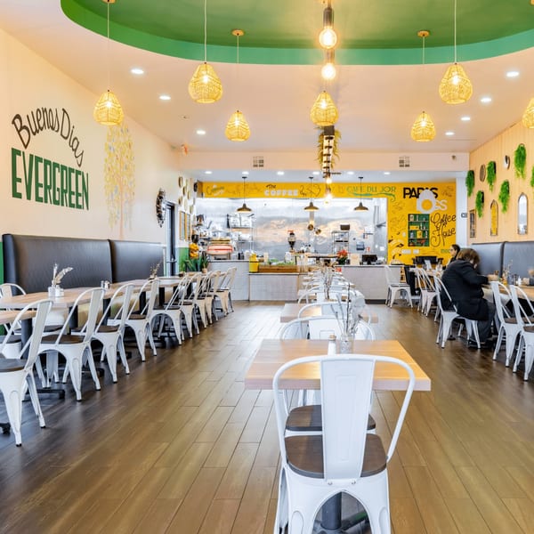 Bright, spacious interior of Papas and Eggs restaurant with tables, chairs, and a counter area.