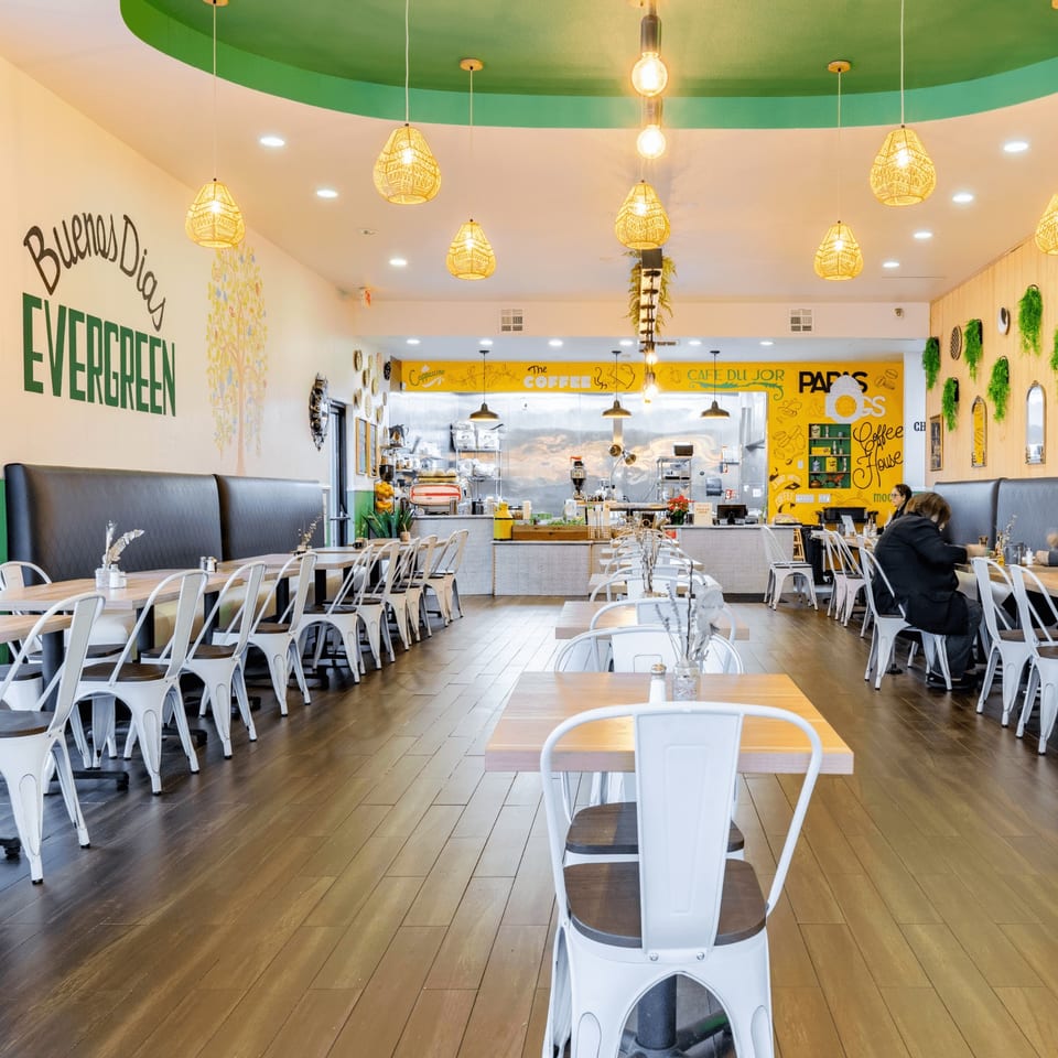 Bright, spacious interior of Papas and Eggs restaurant with tables, chairs, and a counter area.
